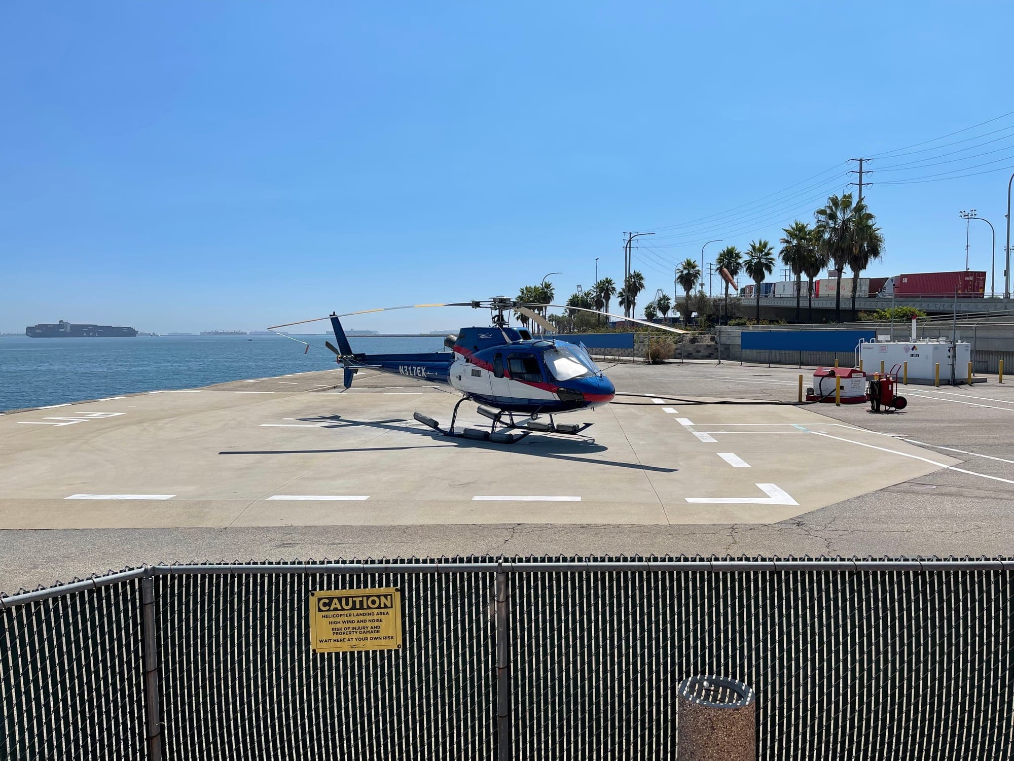 A helicopter waiting on the mainland pad