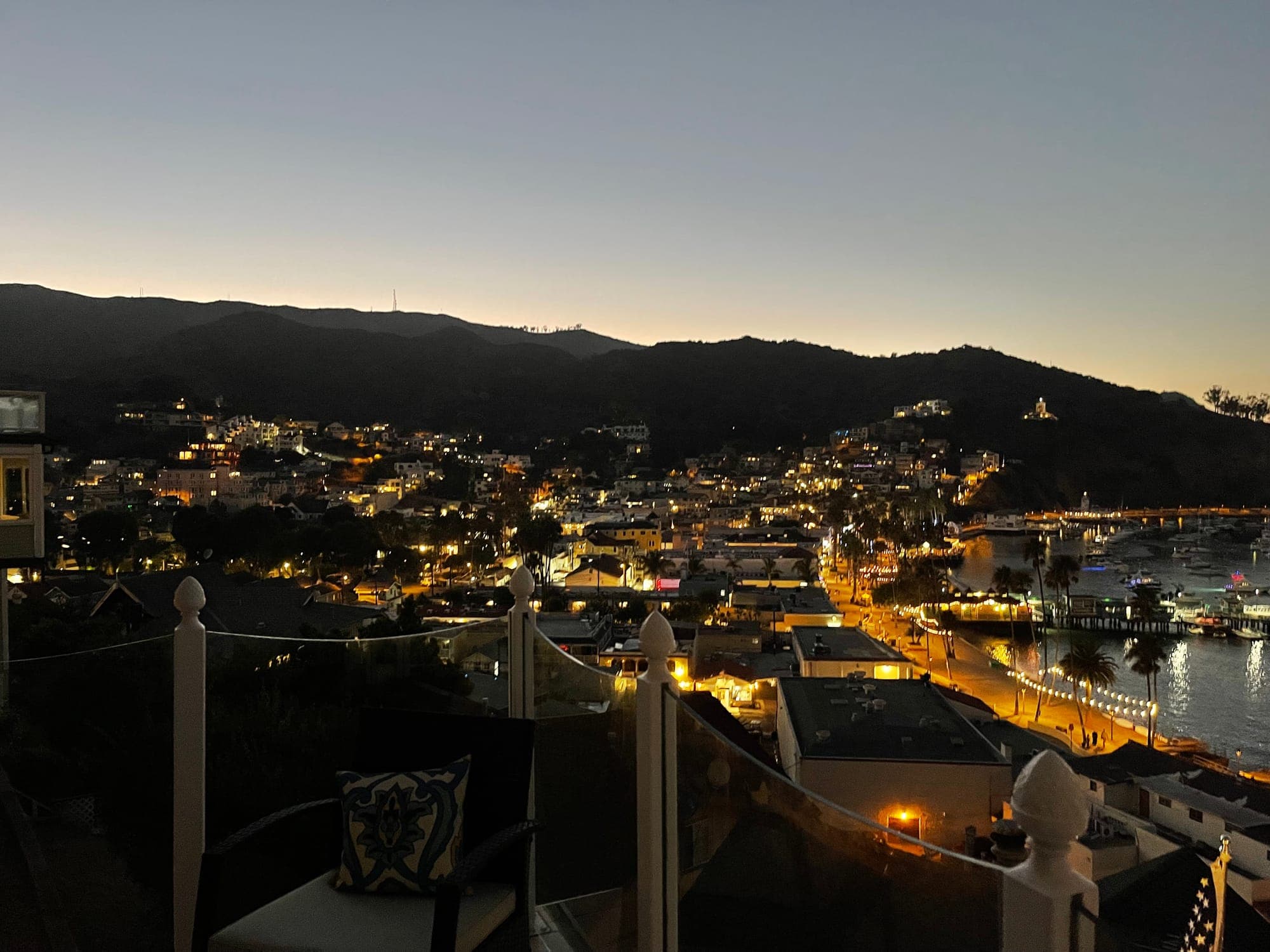 The lights of Avalon at night below the hills